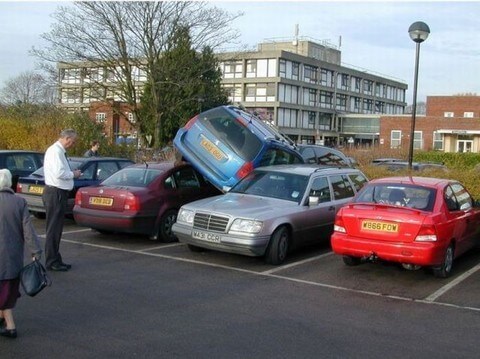 car-ontop-of-inbetween-car-in-parking-lot